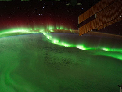 the northern lights above our planet shine green
