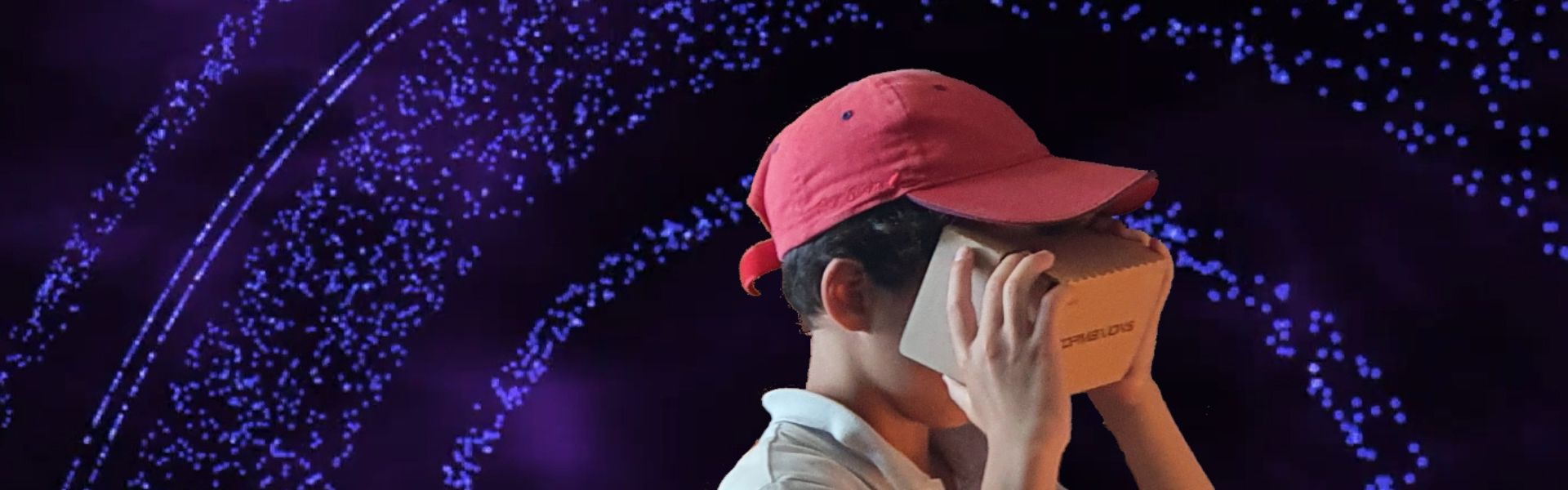 a boy tries a VR headset in front of bright lights