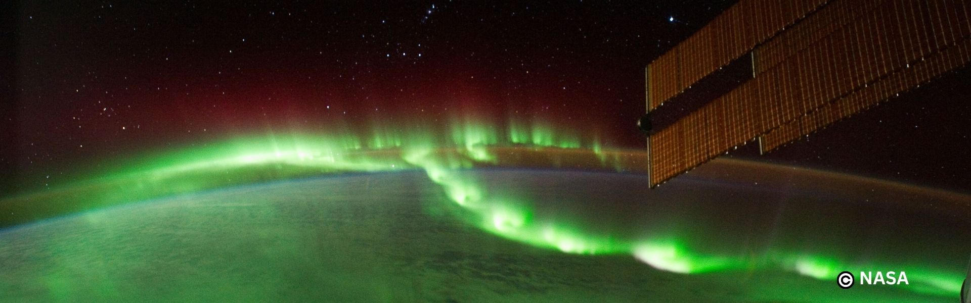 our planet from space with the northern lights shining green