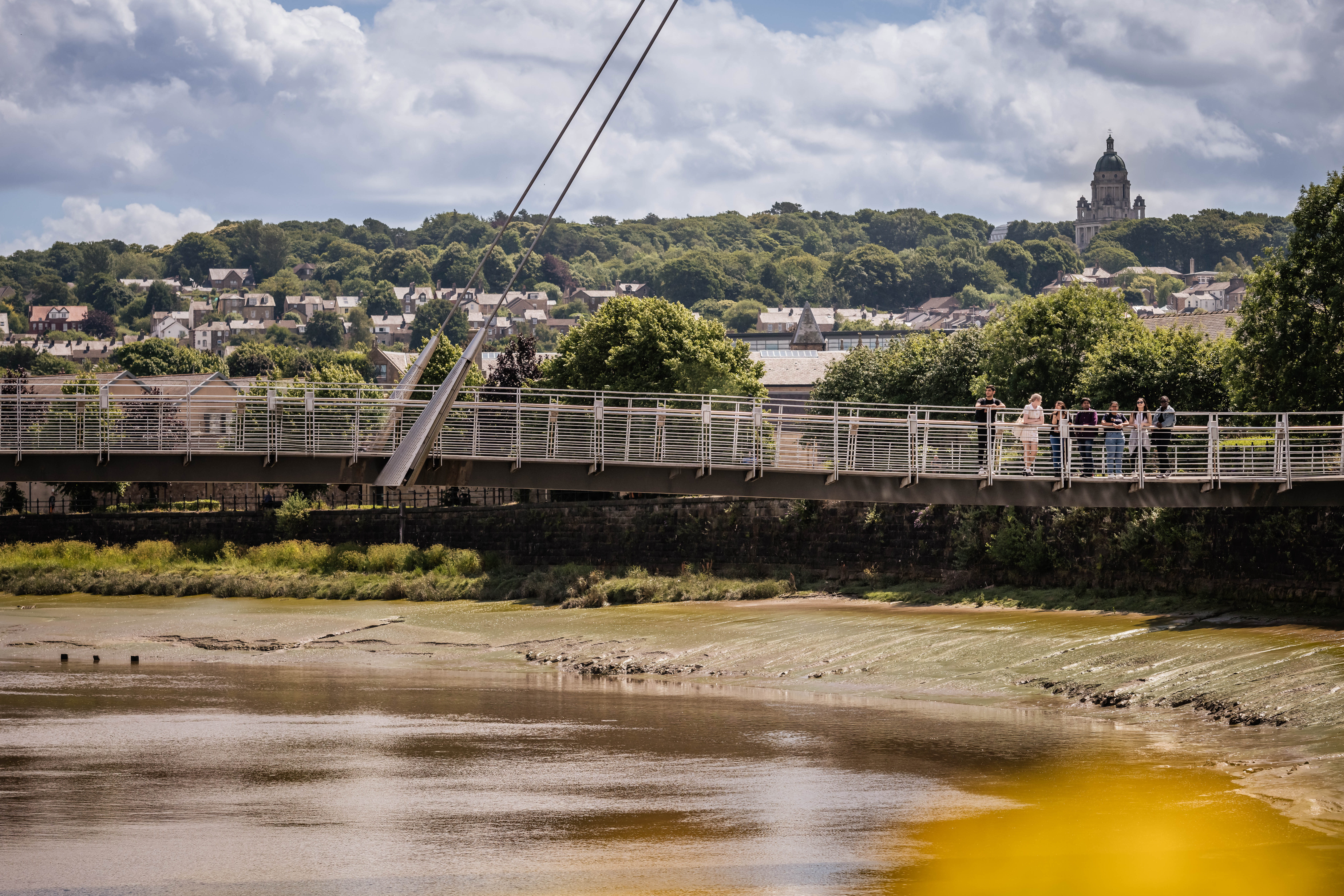 Students walking on the millennium bridge, Lancaster. 