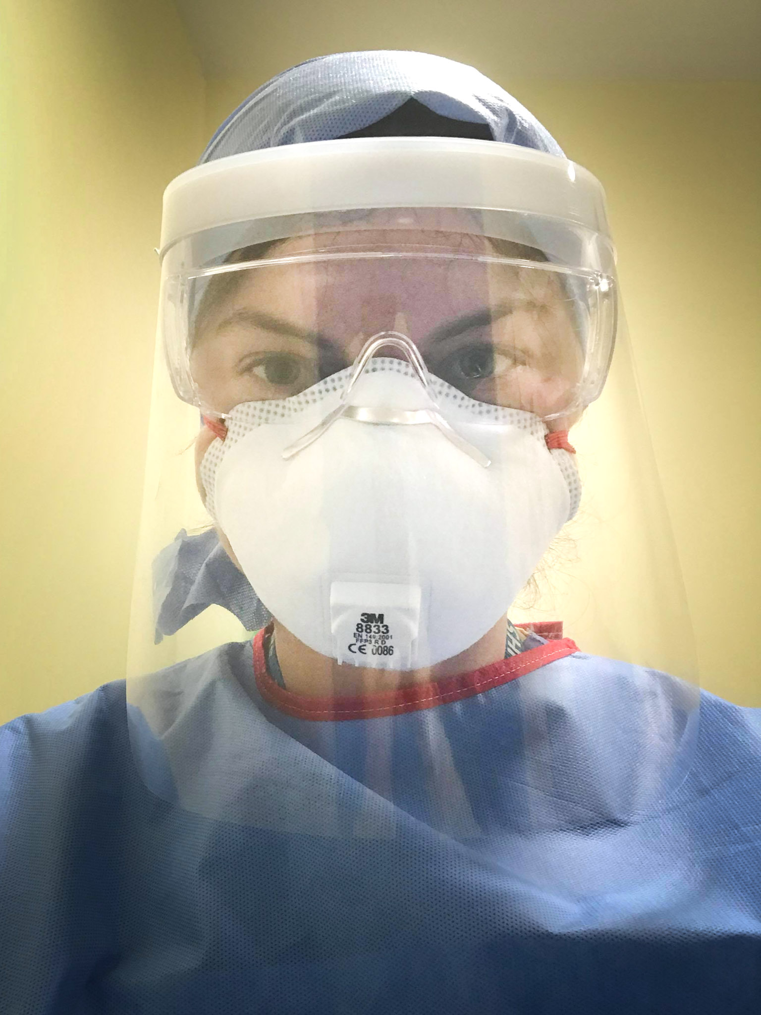 A young woman wearing medical personal protective clothing