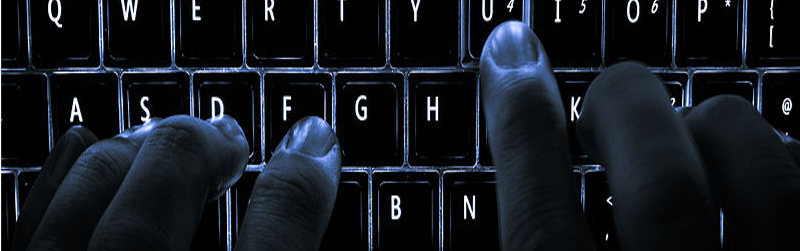 Image showing hands typing in the dark on a backlit keyboard