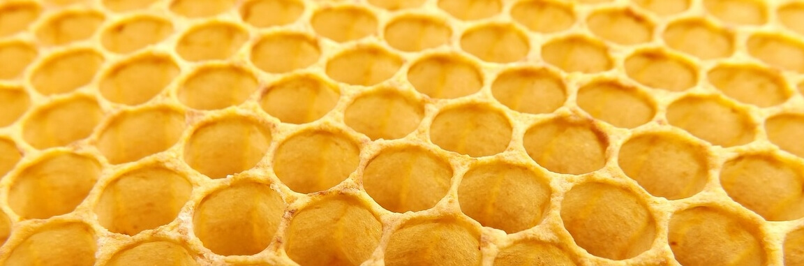 Golden-coloured honeycomb hexagons stretching off into the distance